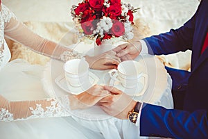 Hands of the bride and groom with rings