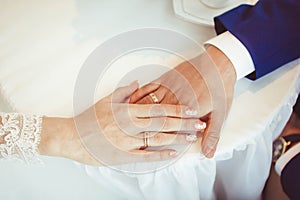 Hands of the bride and groom with rings