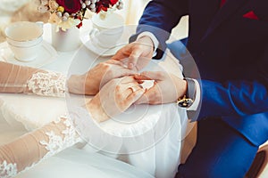 Hands of the bride and groom with rings