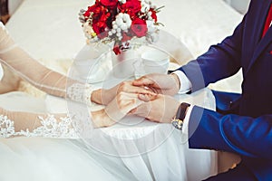Hands of the bride and groom with rings