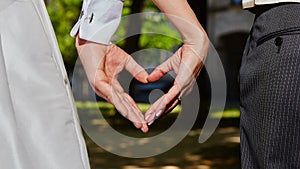 Hands bride and groom in shape of heart