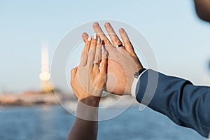 Hands of the bride and groom with wedding rings