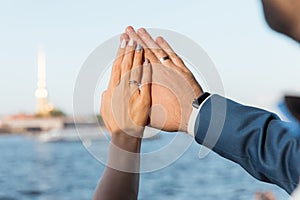 Hands of the bride and groom with wedding rings