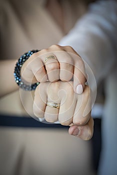 Hands of the bride and groom with wedding rings