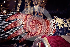 Hands of the bride with heena and gold ornaments. Indian marriage and Pakistani are expensive.