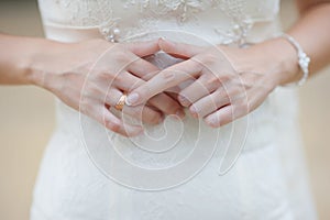 Hands of a bride at a wedding. pointing to the golden ring