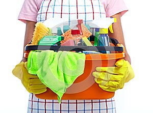 Hands with bucket of cleaning products.