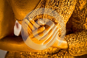 Hands of buddha statue touching the heart on chest level