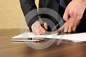 Hands of business men and women studying the documents