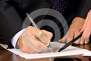 Hands of business men and women studying the documents