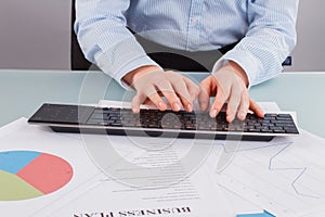 Hands of business woman typing on computer keyboard.