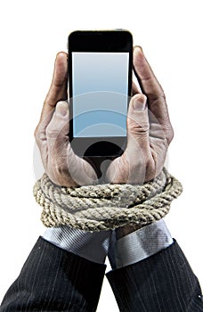 Hands of businessman addicted to mobile phone rope bond wrists in smartphone internet addiction