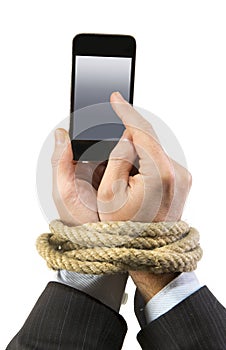 Hands of businessman addicted to mobile phone rope bond wrists in smartphone internet addiction