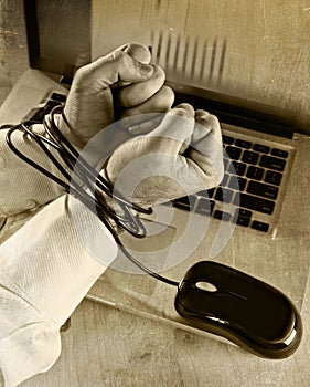 Hands of businessman addicted to work bond with mouse cable to computer laptop in workaholic