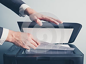 Hands of businessman copying document photo