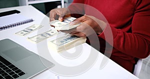 Hands of businessman counting and distributing money