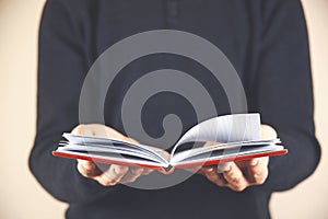 In the hands of a businessman an open notebook