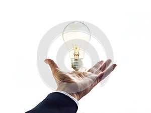 Hands of a businessman reaching to towards light bulb, business concept