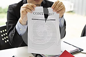 Hands of businessman ripping contract agreement paper,contract canceled, photo
