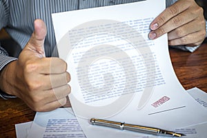 Hands of businessman stamp on paper document to approve business investment contract agreement