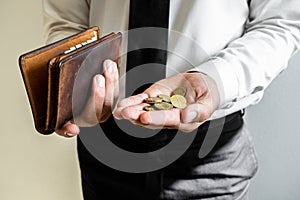 The hands of businessmen holding coins and wallets to save money, expand a growing business to success and save for retirement