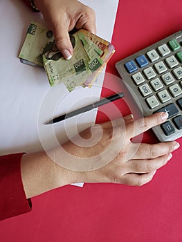 hands of a businesswoman counting mexican banknotes