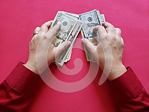 hands of a businesswoman holding american dollars banknotes