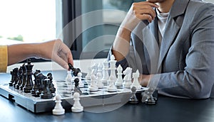 The hands of businesswomen two people moving chess in chess competitions demonstrate leadership, followers, and strategic plans,
