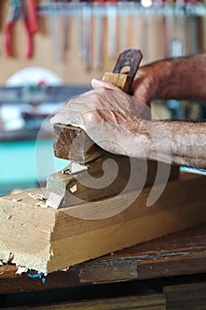 Hands of a cabinetmaker sanding photo