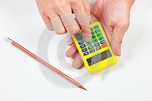 Hands calculate using a pocket calculator on white background