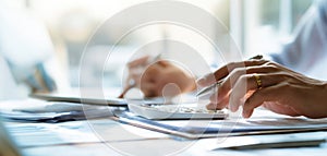 The hands calculating financial data in a modern office setting. AI generated image