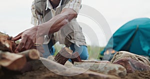 Hands, camping and wood to start fire by tent for heat, cooking or light on survival adventure on vacation. Person