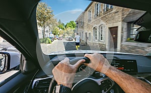 Hands of car driver on steering wheel, road trip, driving on highway road