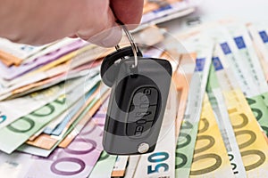 Hands with car keys on euro money background