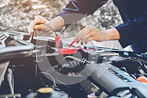 Hands of car mechanic working in auto repair service.