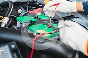 Hands of car mechanic working in auto repair service