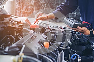 Hands of car mechanic working auto repair service.