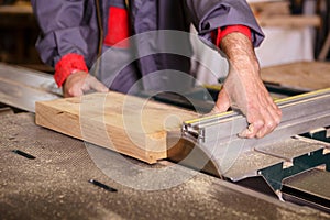 Hands carpenter working with a circular saw