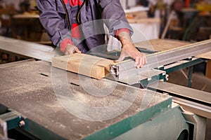 Hands carpenter working with a circular saw