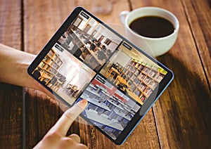 Hands of caucasian woman holding tablet with view from security cameras at library on screen