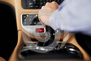 Hands, center console and gear of car for shift, transmission and speed change for driving or journey. Auto, stickshift