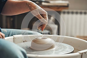 The hands of Ceramist create pottery on a pottery wheel