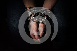 Hands chained in chains isolated on black background