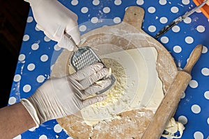 Hands of a chef grating cheese
