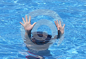 Hands of child drowning