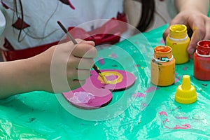 Hands of a child engaged in creativity