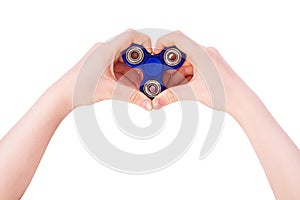 Hands of a child are holding a blue spinner