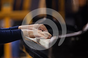 Hands of a child playing the piano