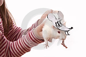 Hands childl hold rat in a mask