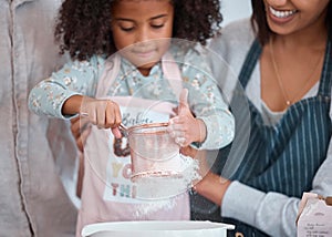 Hands, children and baking with a girl learning how to bake in the kitchen of her home with mother. Flour, kids and